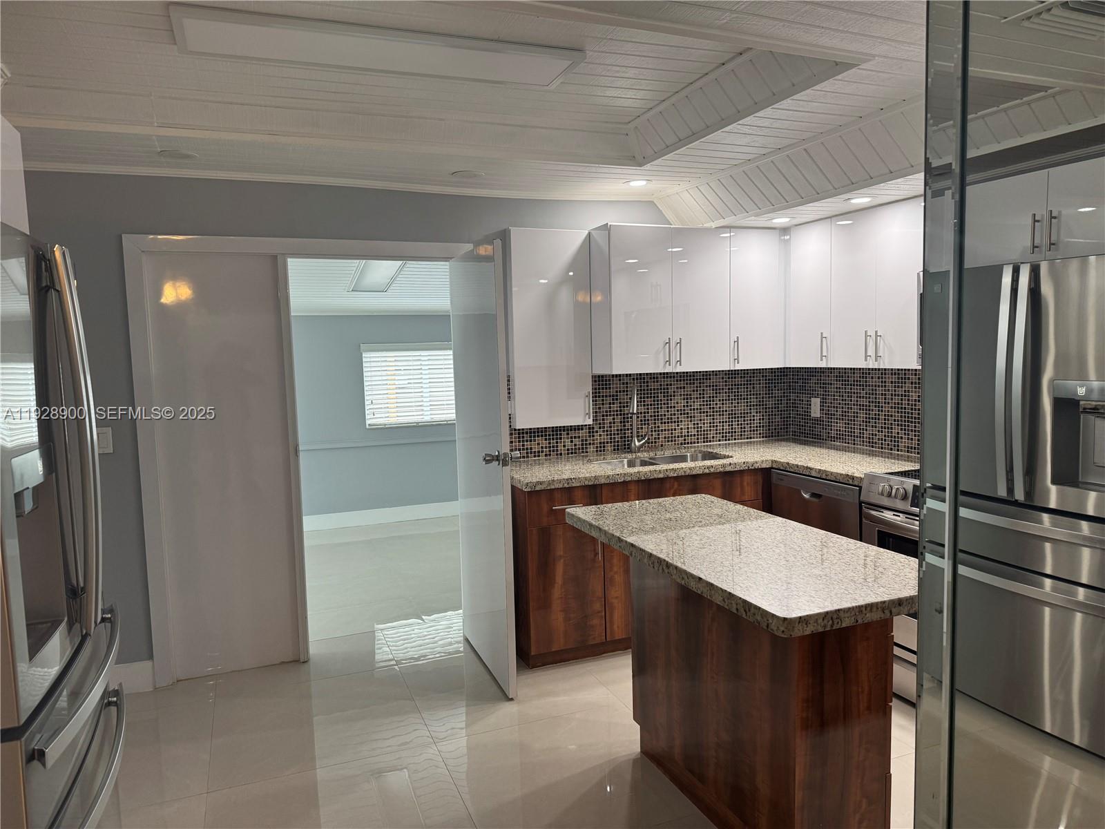 881 Hialeah Drive Hialeah, FL 33010 - Photo 6 of 36 a kitchen with stainless steel appliances granite countertop a sink stove and refrigerator