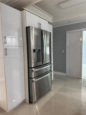 a kitchen with a stove sink and cabinets