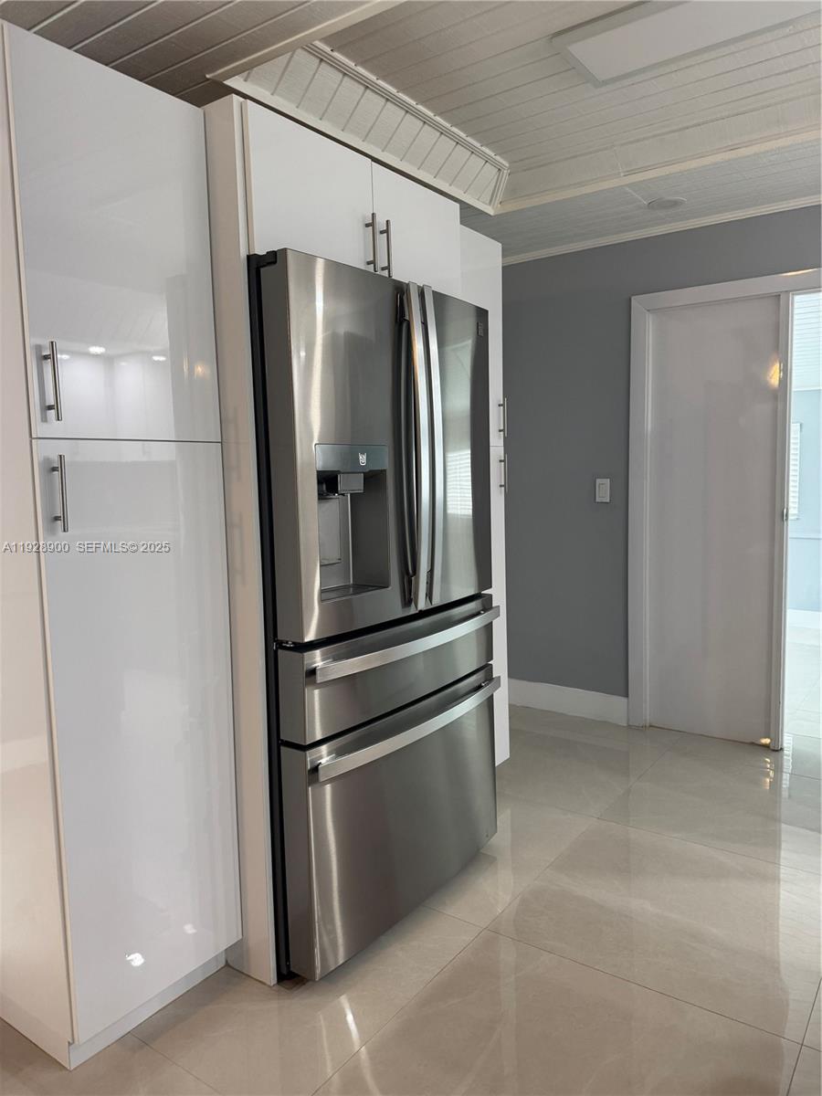 881 Hialeah Drive Hialeah, FL 33010 - Photo 7 of 36 a metallic refrigerator freezer sitting in a kitchen