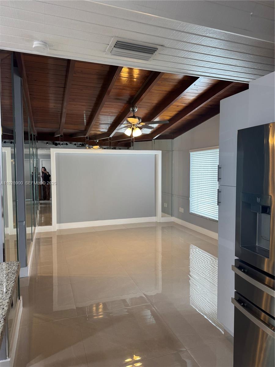 881 Hialeah Drive Hialeah, FL 33010 - Photo 9 of 36 a kitchen with stainless steel appliances wooden cabinets and a stove top oven