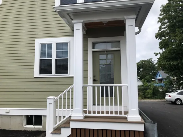 a view of a house with a small deck