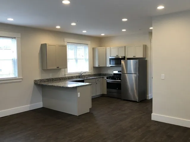 a kitchen with refrigerator and window