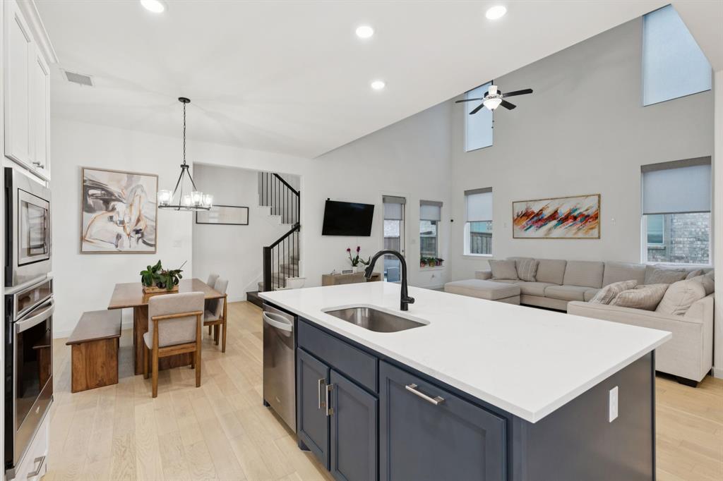 547 Embargo Drive Fate, TX 75189 - Photo 12 of 36 a kitchen with a sink and a refrigerator