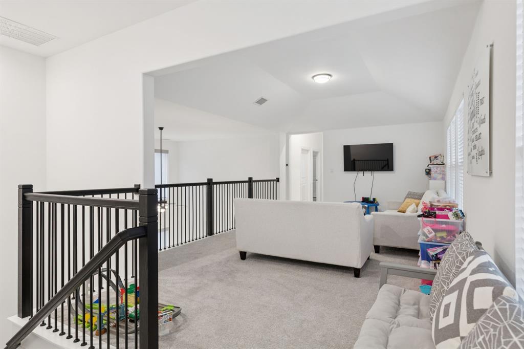 547 Embargo Drive Fate, TX 75189 - Photo 19 of 36 a room with furniture and flat screen tv