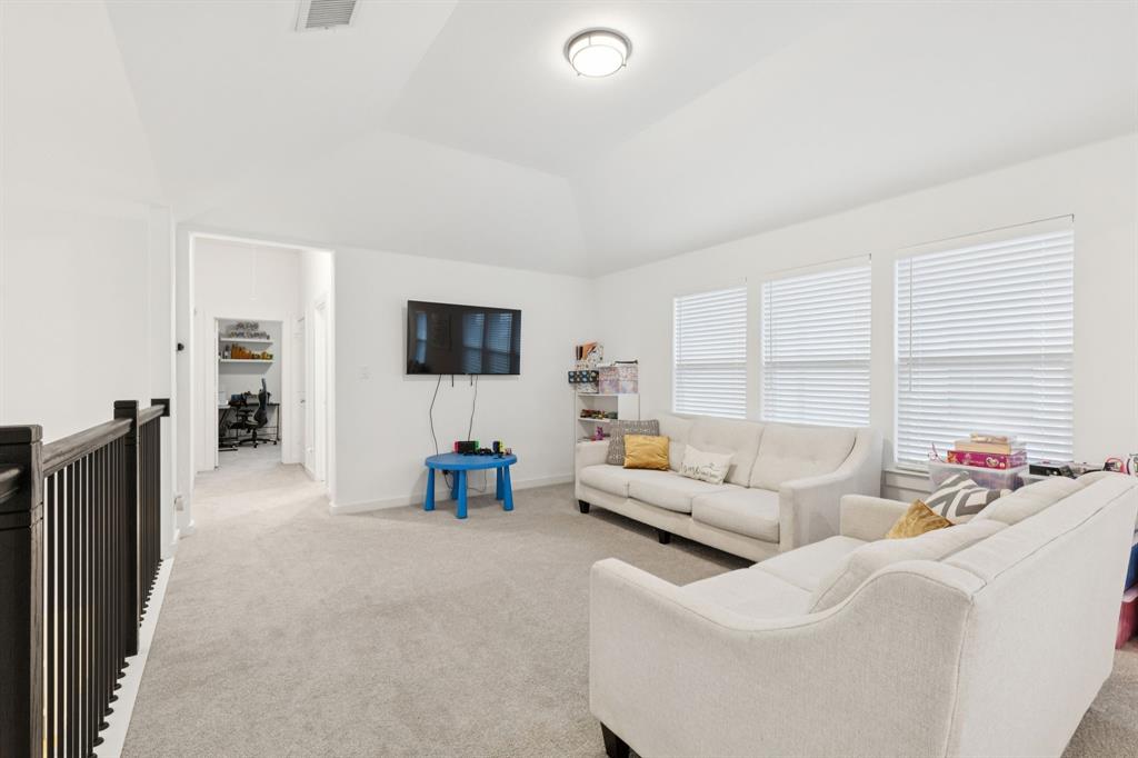 547 Embargo Drive Fate, TX 75189 - Photo 20 of 36 a living room with furniture and a flat screen tv