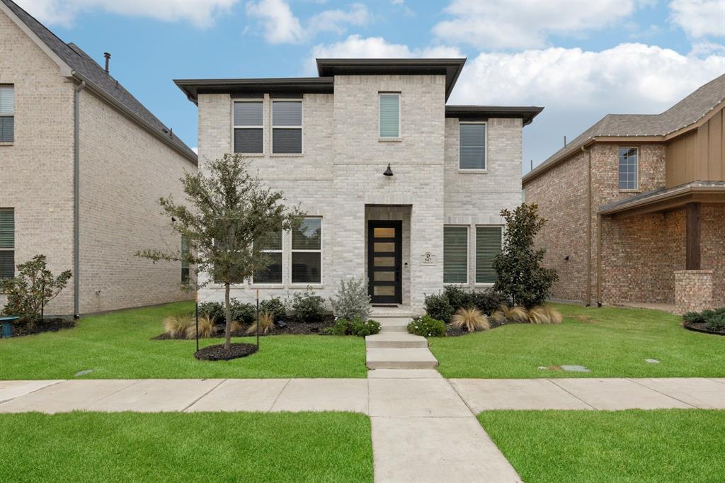 547 Embargo Drive Fate, TX 75189 - Photo 2 of 36 a front view of a house with a yard and garage