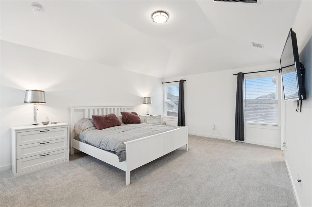 547 Embargo Drive Fate, TX 75189 - Photo 22 of 36 a room with a bed and a night stand