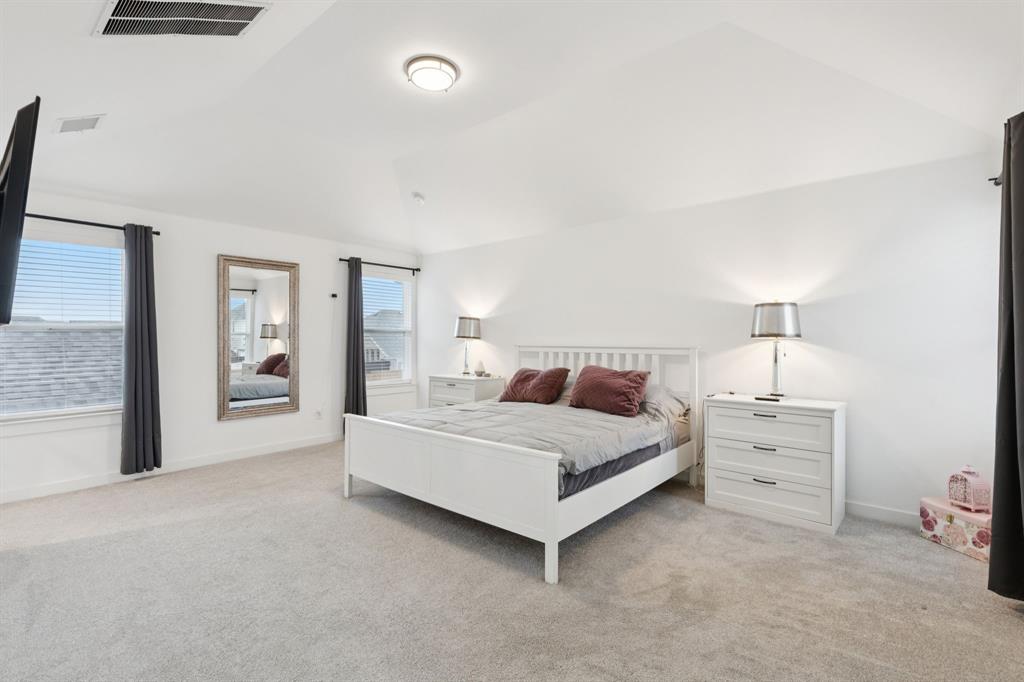 547 Embargo Drive Fate, TX 75189 - Photo 23 of 36 a room with a bed and a night stand