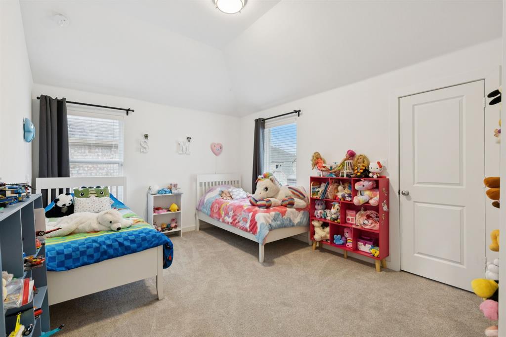 547 Embargo Drive Fate, TX 75189 - Photo 25 of 36 a bedroom with bed and a couch