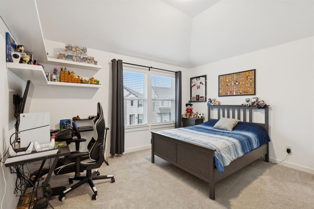 547 Embargo Drive Fate, TX 75189 - Photo 26 of 36 a bedroom with a bed and a desk