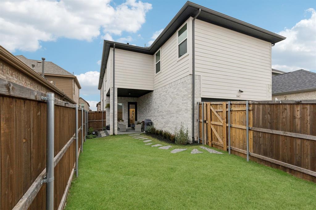547 Embargo Drive Fate, TX 75189 - Photo 30 of 36 a view of a backyard with wooden fence