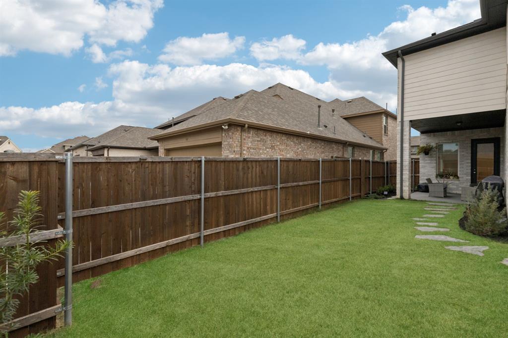 547 Embargo Drive Fate, TX 75189 - Photo 31 of 36 a view of a backyard with potted plants