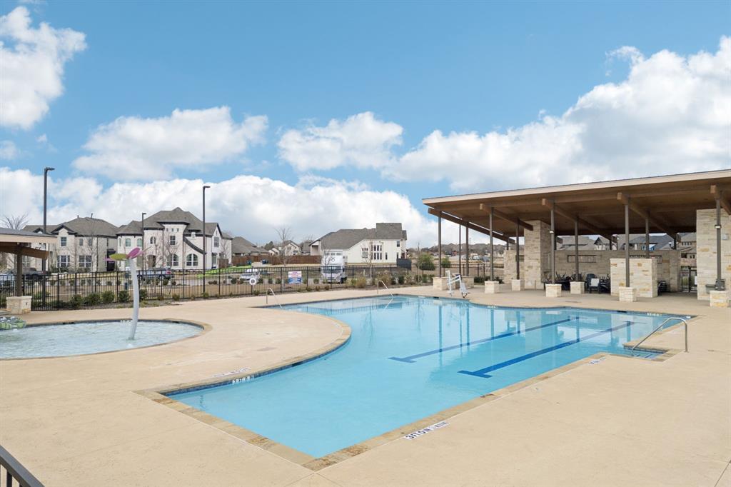 547 Embargo Drive Fate, TX 75189 - Photo 32 of 36 a view of a swimming pool with an outdoor seating