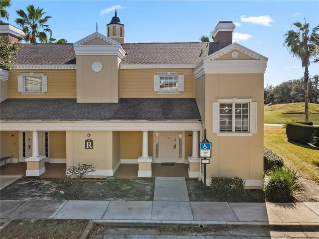 an aerial view of a swimming pool with a yard and seating area