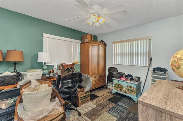 a gym room with furniture a rug and gym equipment