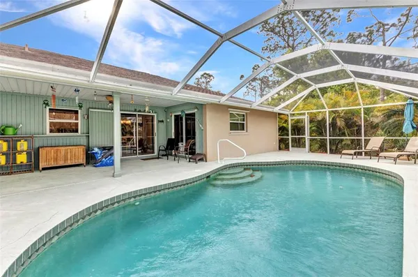 a view of swimming pool with outdoor seating