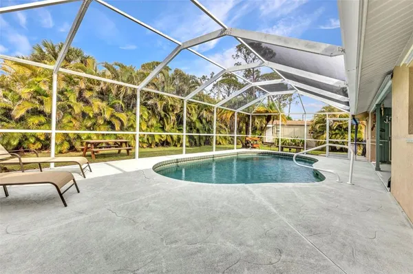 a view of a swimming pool with outdoor seating