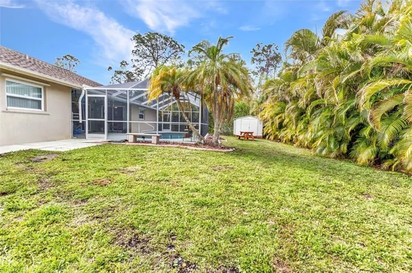 a view of a house with a yard and potted plants
