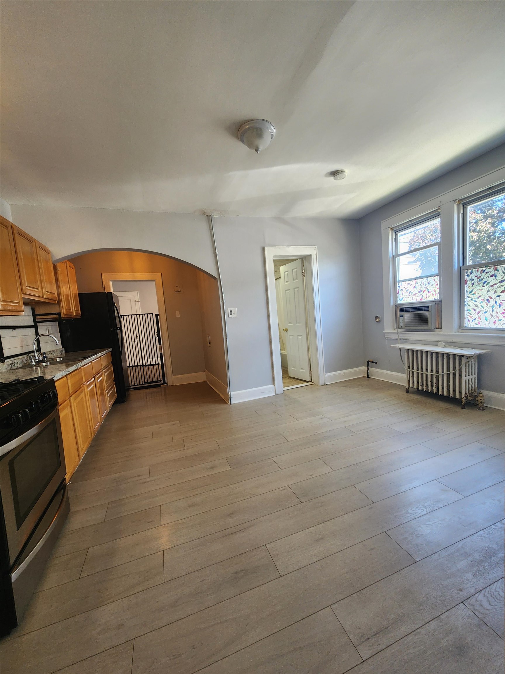 261 Centre Avenue, Unit 1 Secaucus, NJ 07094 - Photo 3 of 11 a view of an empty room with a fireplace and windows