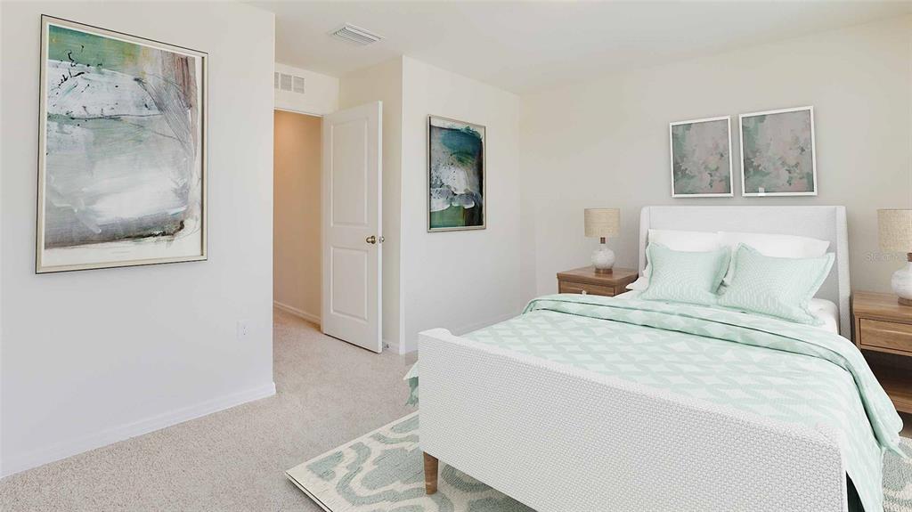 17688 Acorn Drop Road Land O Lakes, FL 34638 - Photo 14 of 15 a bedroom with a bed and a painting on the wall