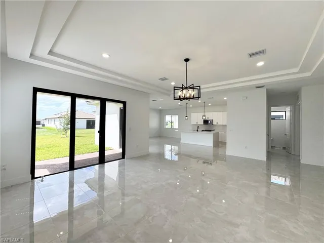 a view of kitchen with furniture and refrigerator