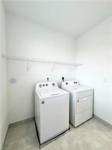 a view of empty room with wooden floor and window