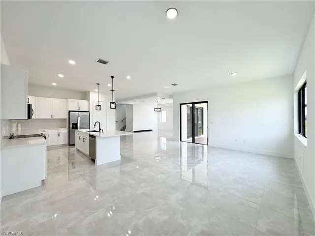 a room with furniture a flat screen tv and a large window