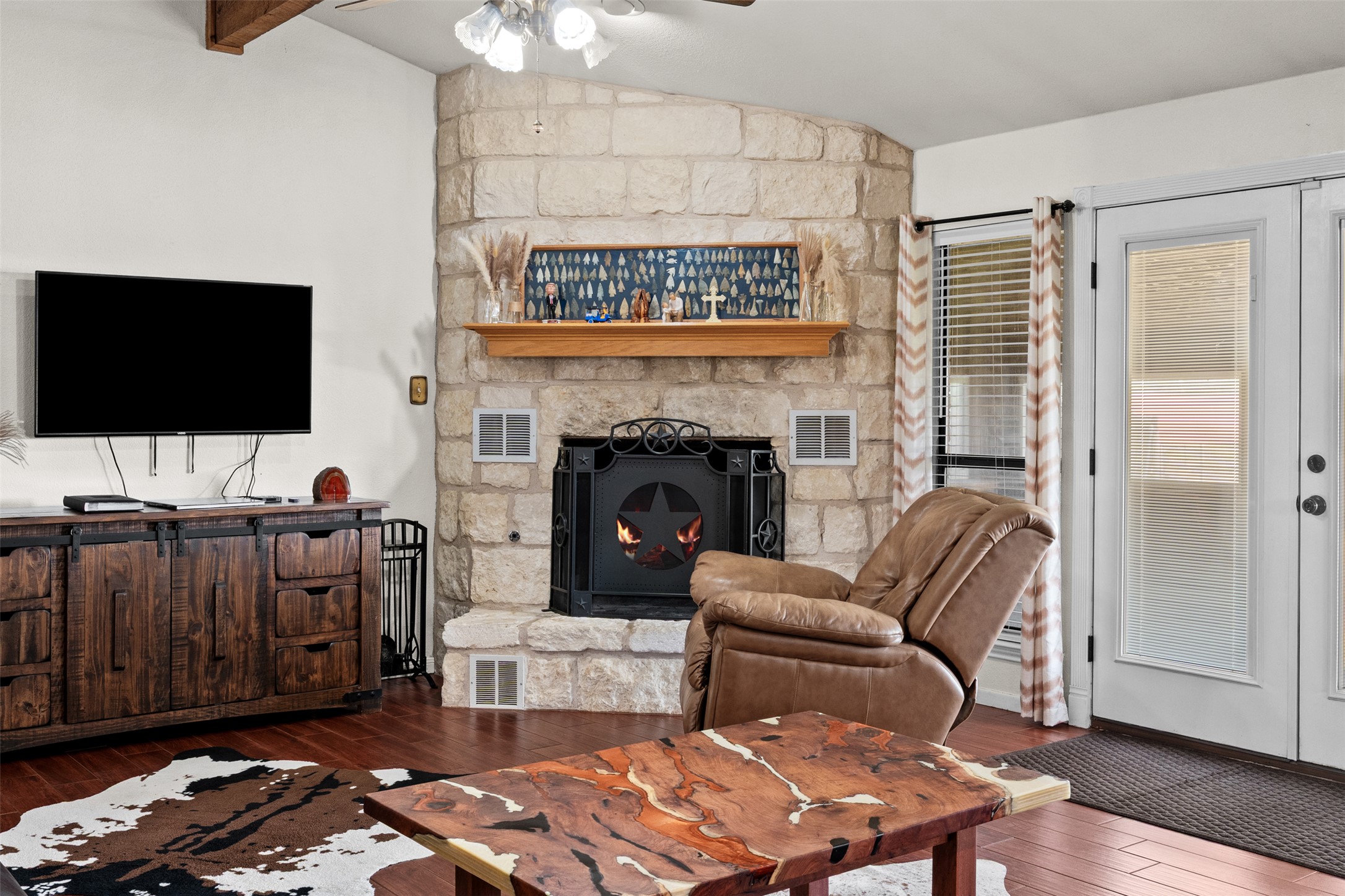 1512 Panther Loop Pflugerville, TX 78660 - Photo 20 of 40 A stone-clad fireplace with a decorative screen creates a focal point in this inviting living space.
