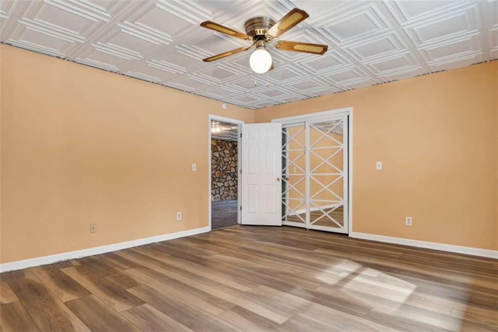1951 Swords Trail Buckhead, GA 30625 - Photo 24 of 102 an empty room with wooden floor fan and windows