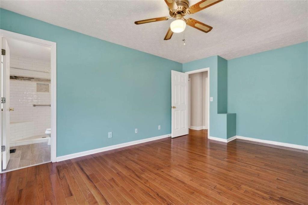1951 Swords Trail Buckhead, GA 30625 - Photo 35 of 102 an empty room with wooden floor chandelier fan and closet area