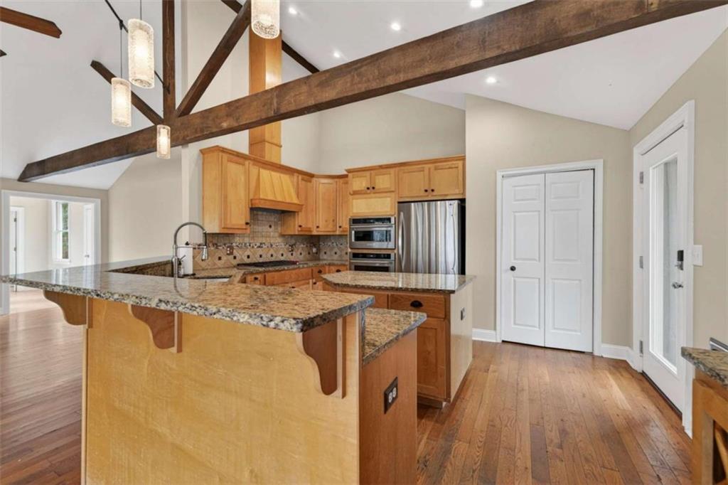 1951 Swords Trail Buckhead, GA 30625 - Photo 70 of 102 a kitchen with stainless steel appliances granite countertop a refrigerator a sink dishwasher a stove and white countertops with wooden floor