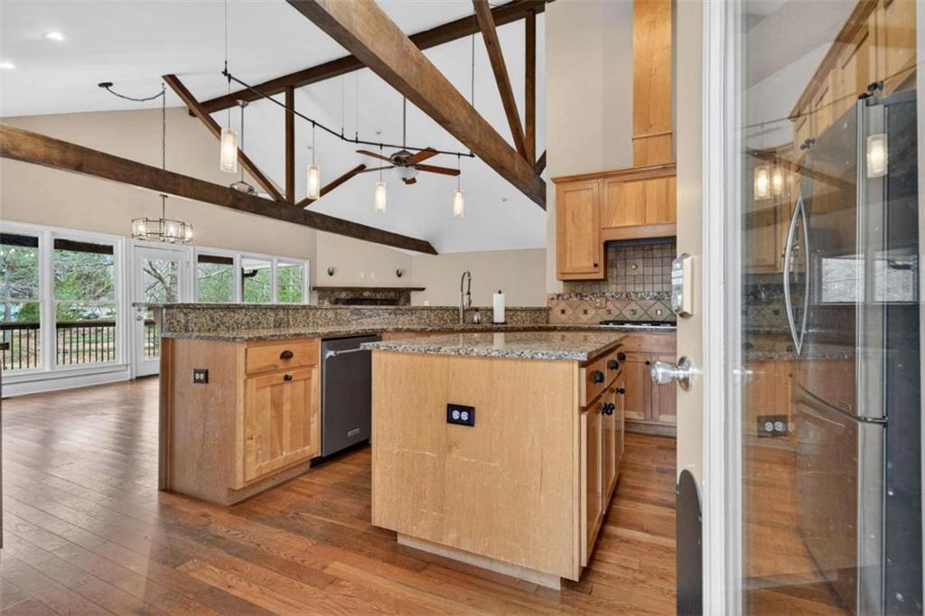 1951 Swords Trail Buckhead, GA 30625 - Photo 76 of 102 a kitchen with stainless steel appliances granite countertop a sink a refrigerator a washer and dryer