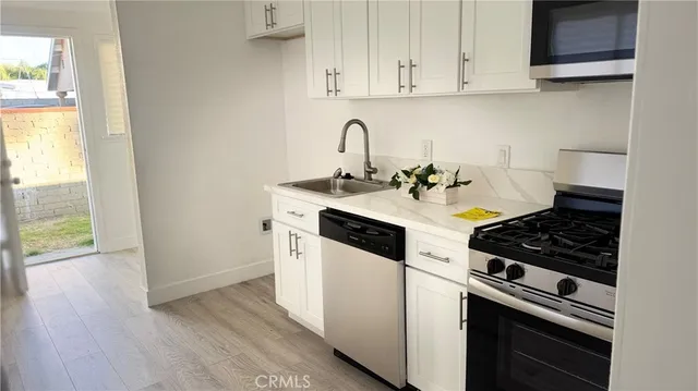 a white stove top oven sitting inside of a kitchen