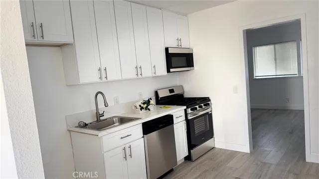 a utility room with sink dryer and washer