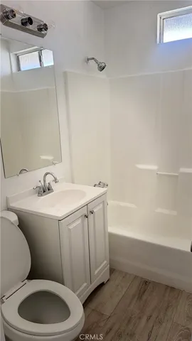 a bathroom with a sink a toilet and bathtub