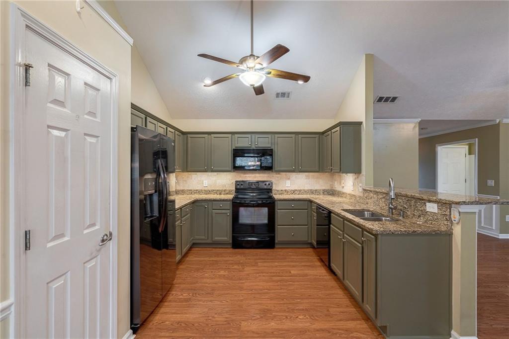 245 Memory Lane Winder, GA 30680 - Photo 15 of 62 a kitchen with stainless steel appliances granite countertop a stove and a refrigerator