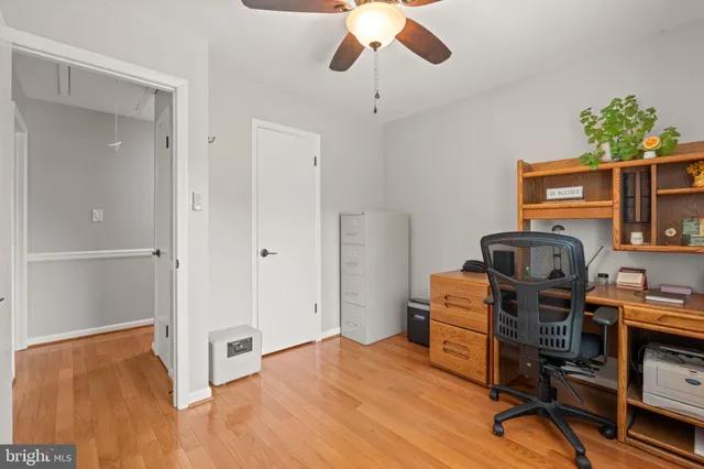 a view of a workspace with furniture and a window
