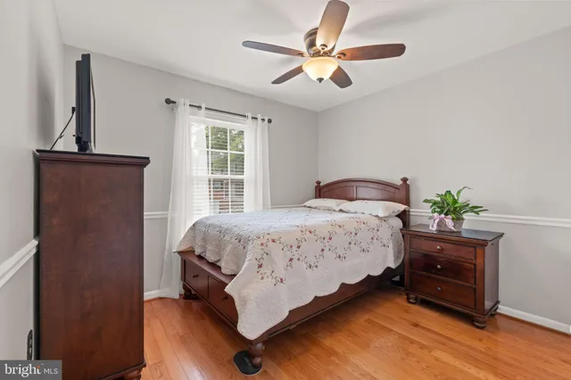 a bedroom with a bed and a potted plant
