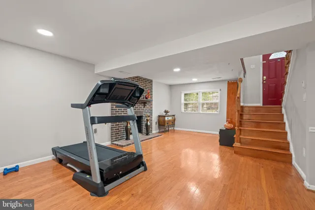 a view of a room with wooden floor and window