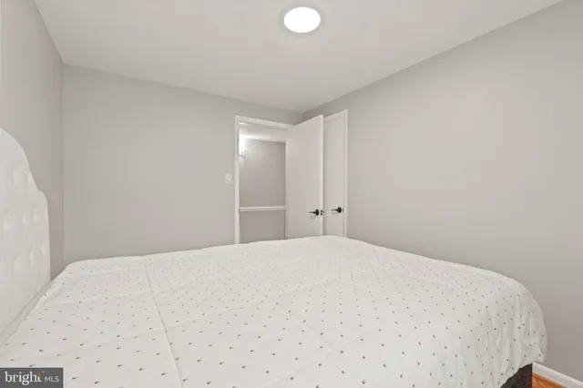 a large white bed in a white room