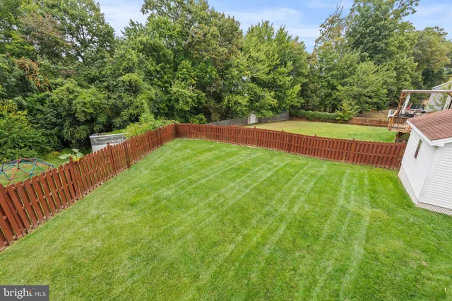a view of a backyard with swimming pool