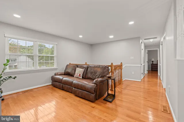 a living room with furniture window and wooden floor