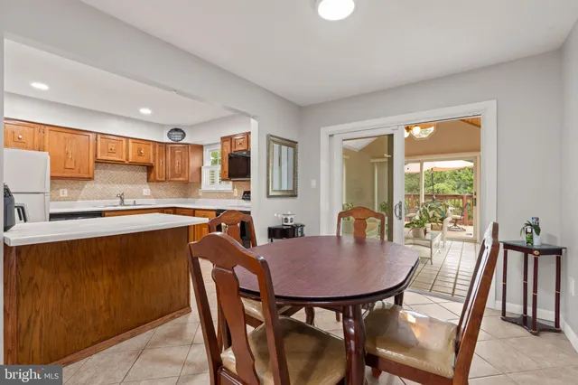 a kitchen with a table chairs sink and cabinets