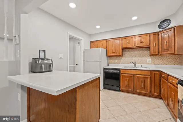 a kitchen with stainless steel appliances a refrigerator and a sink