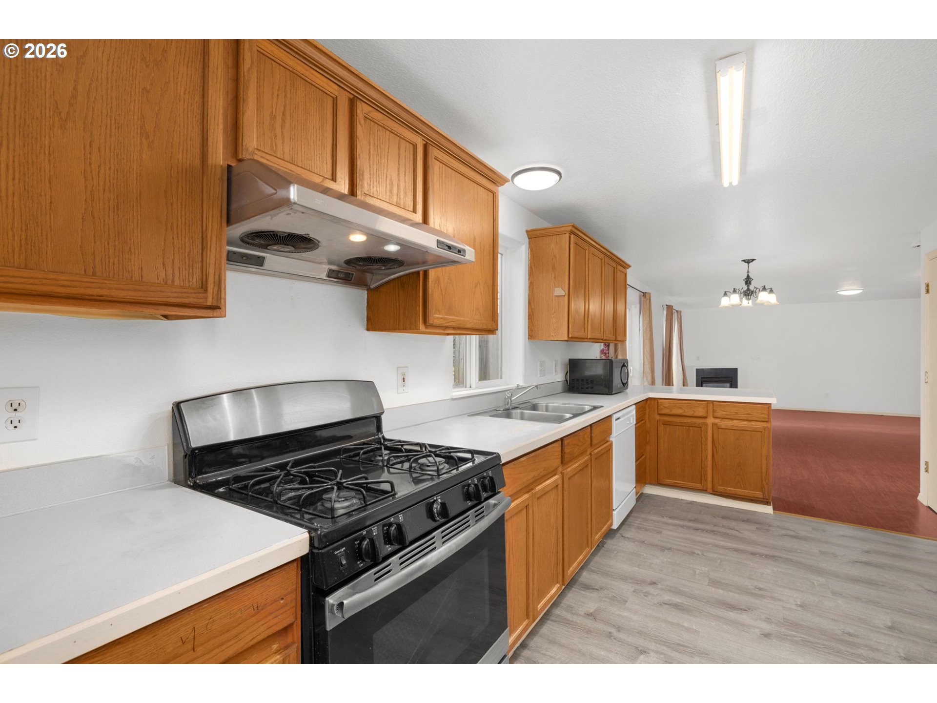 8704 Southeast Rhone Street Portland, OR 97266 - Photo 11 of 24 a kitchen with stainless steel appliances granite countertop a stove and a sink