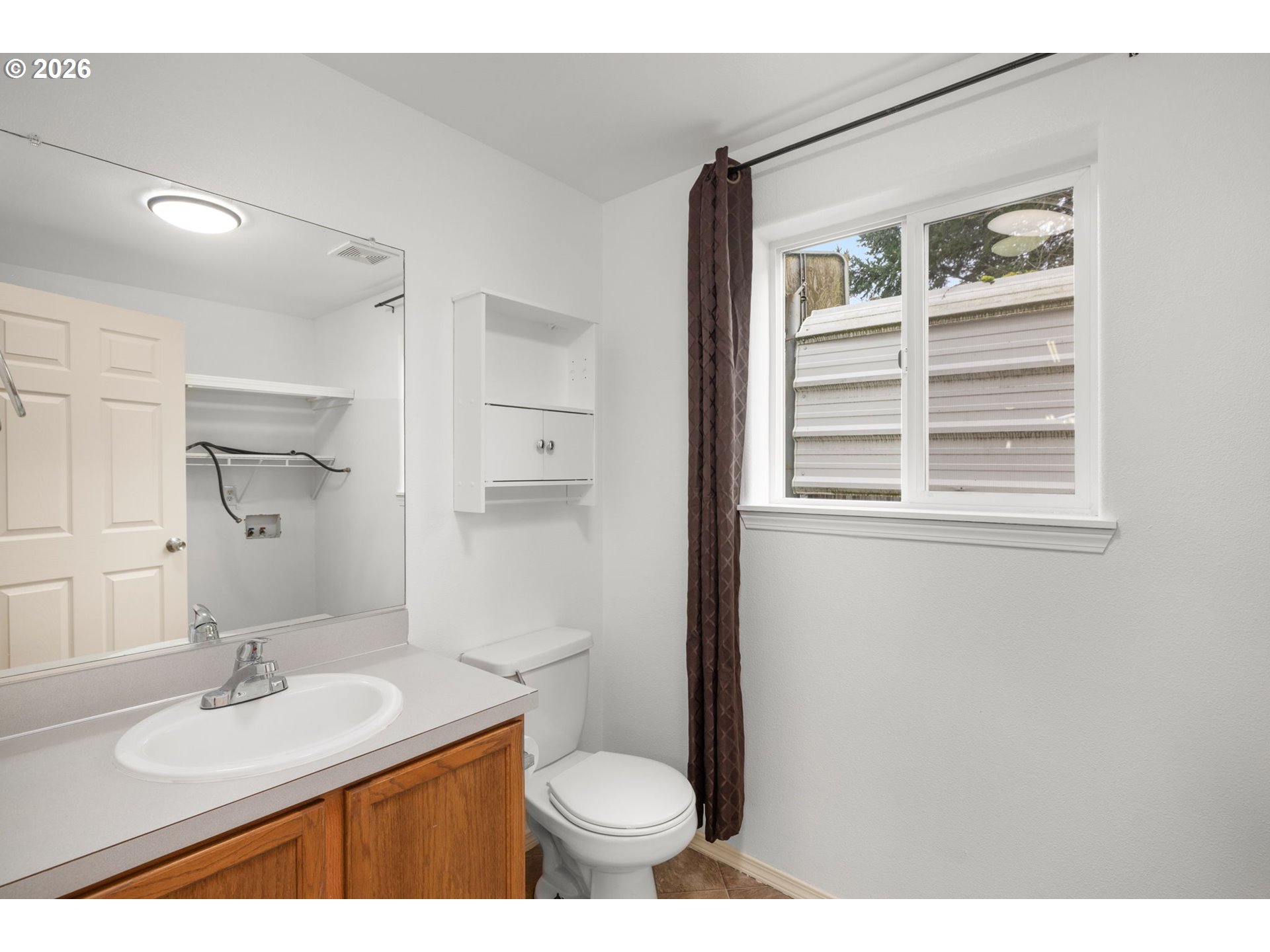 8704 Southeast Rhone Street Portland, OR 97266 - Photo 12 of 24 a bathroom with a sink toilet vanity and mirror