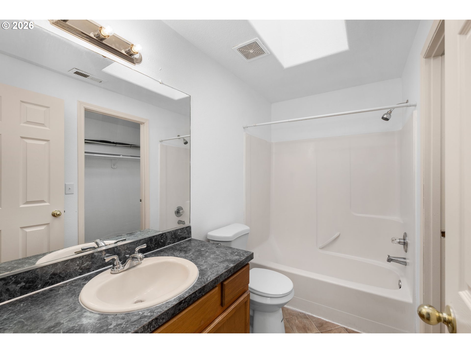 8704 Southeast Rhone Street Portland, OR 97266 - Photo 15 of 24 a bathroom with a granite countertop sink toilet and shower