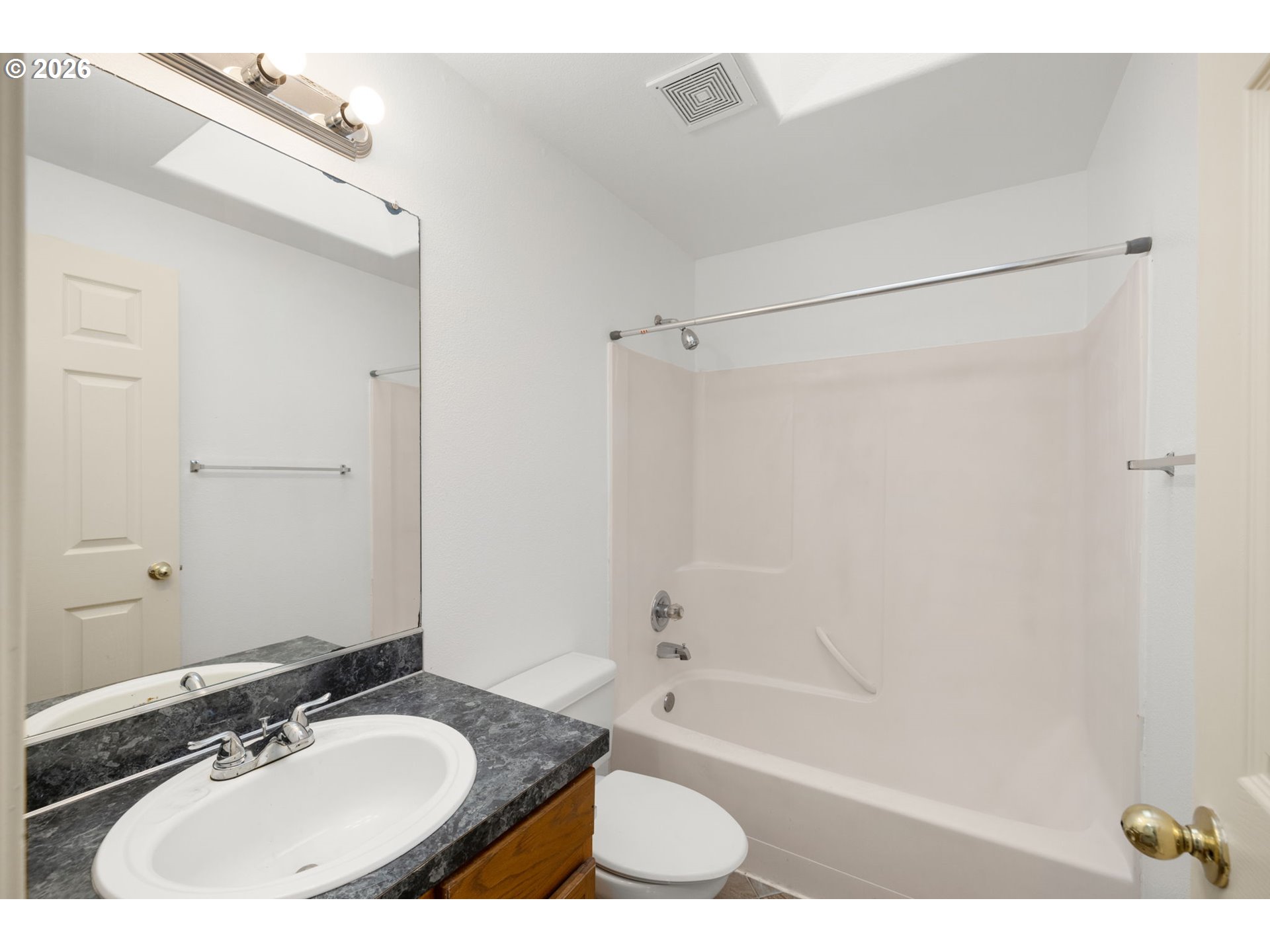8704 Southeast Rhone Street Portland, OR 97266 - Photo 20 of 24 a bathroom with a bath tub a sink and a mirror