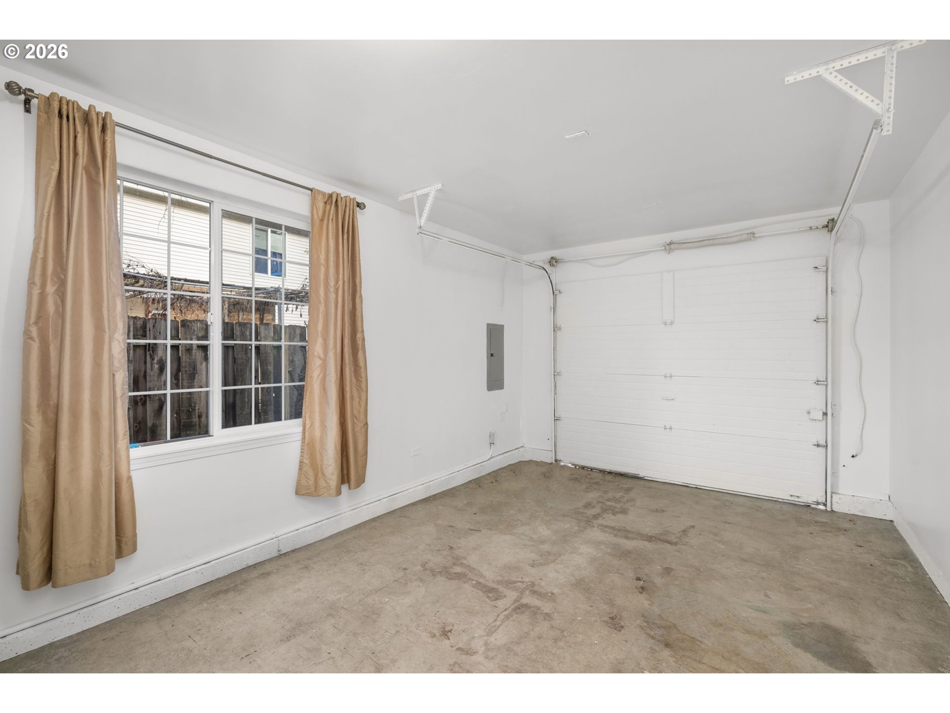 8704 Southeast Rhone Street Portland, OR 97266 - Photo 22 of 24 a view of empty room with windows