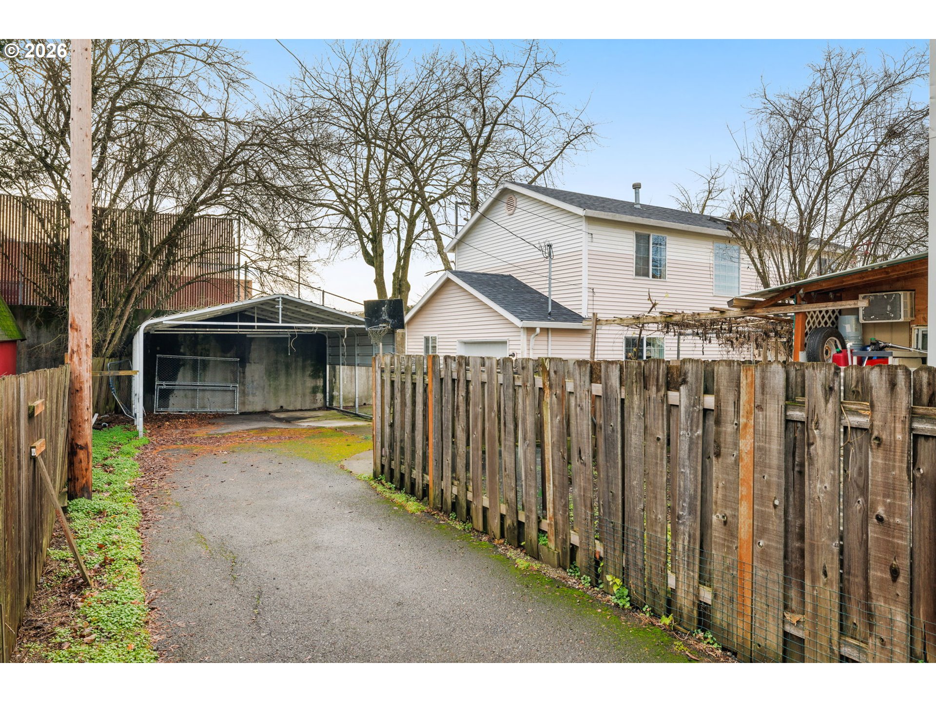 8704 Southeast Rhone Street Portland, OR 97266 - Photo 24 of 24 a view of a house with wooden fence and a yard